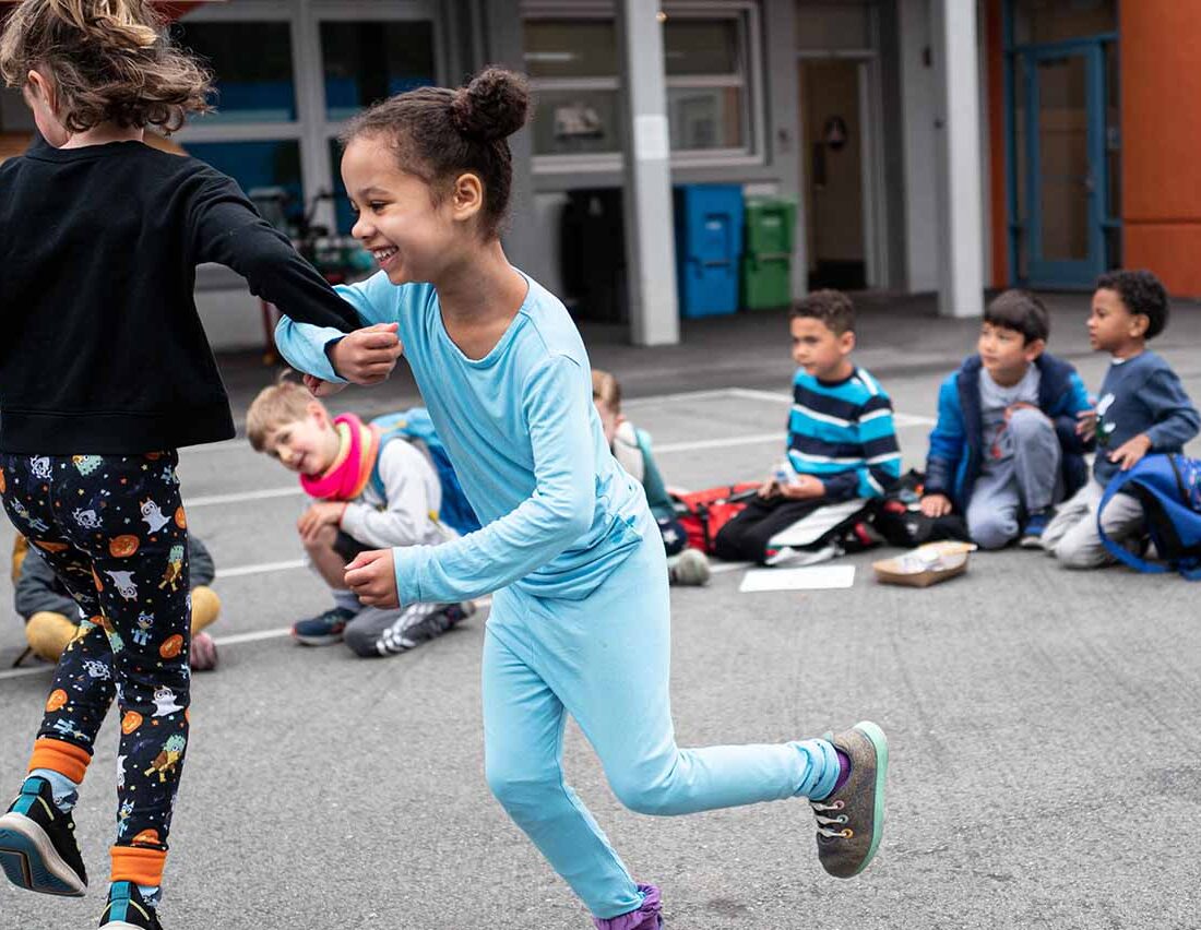 Kids run and play in the school yard